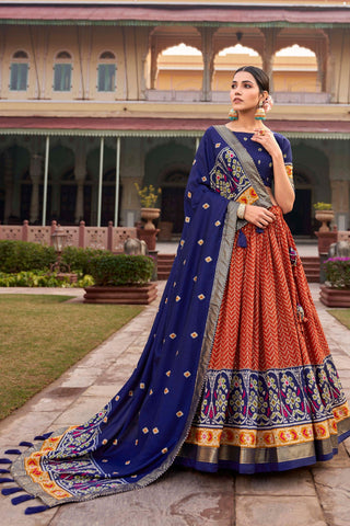 Art Silk Fabric Captivating Orange Color Patola Style Foil Printed Lehenga.