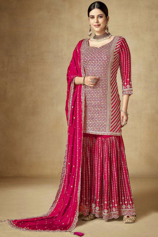 Traditional Embroidered Rani Color Palazzo Suit In Chinon Fabric.