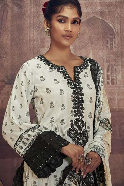 Muslin Embroidered Party Wear Palazzo Salwar Kameez In Off White Color.